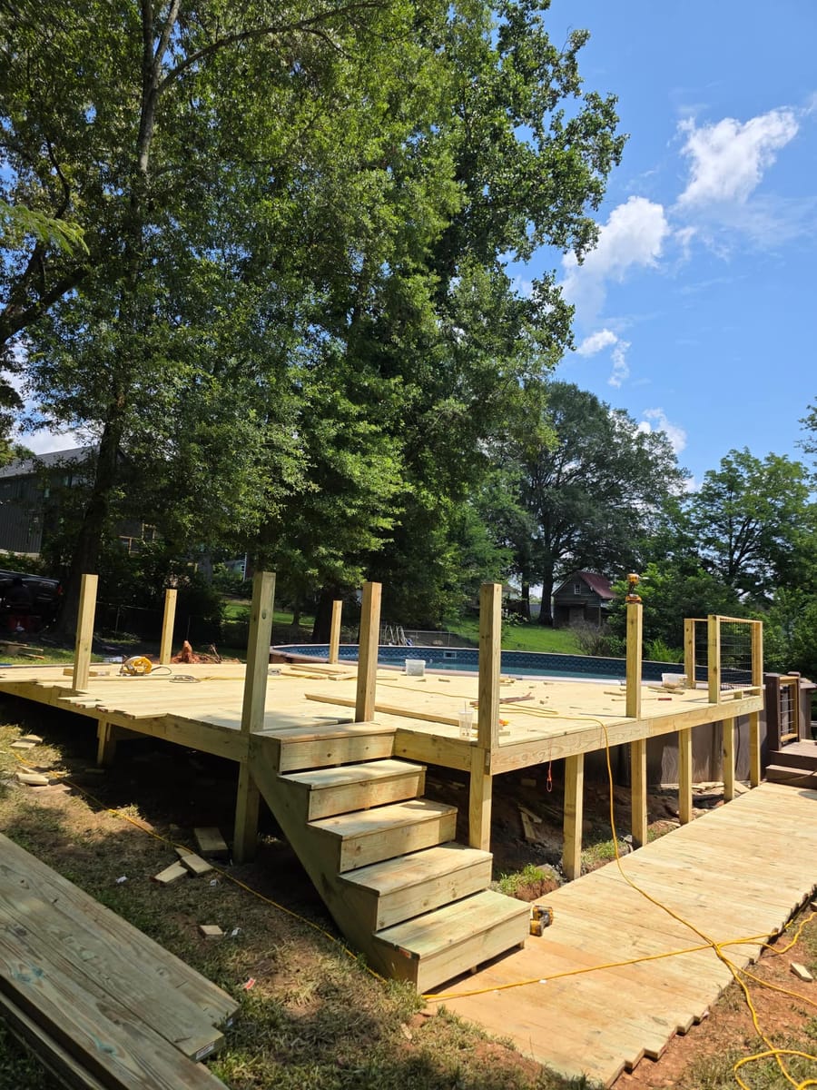 Pool deck framed and boarded around an in-ground pool, with a broad stair run, Ball Ground, Georgia