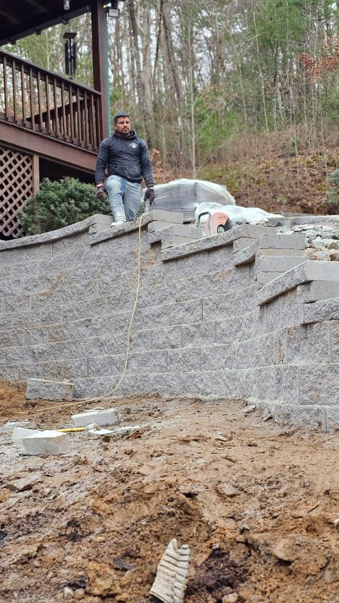 Failed timber retaining wall replaced with segmental concrete block on a steep mountain lot below a cabin, Blue Ridge, Georgia
