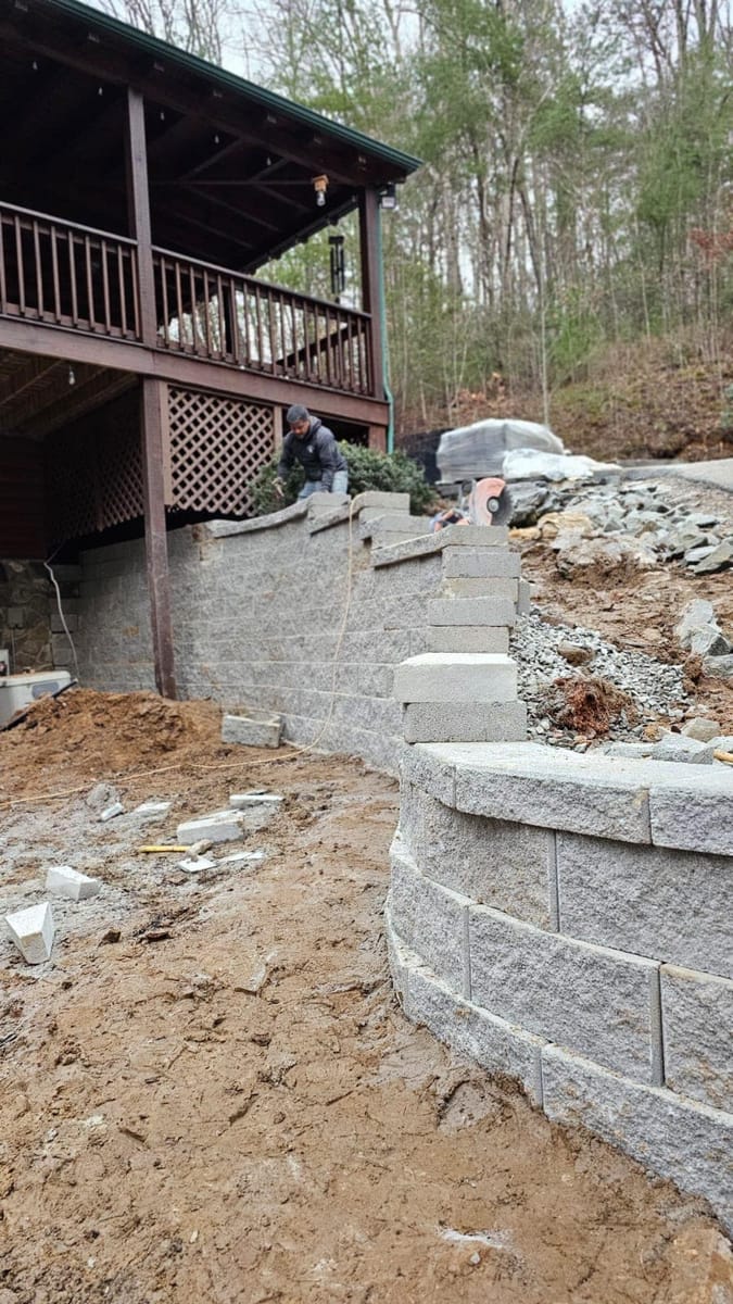 Failed timber retaining wall replaced with segmental concrete block on a steep mountain lot below a cabin, Blue Ridge, Georgia