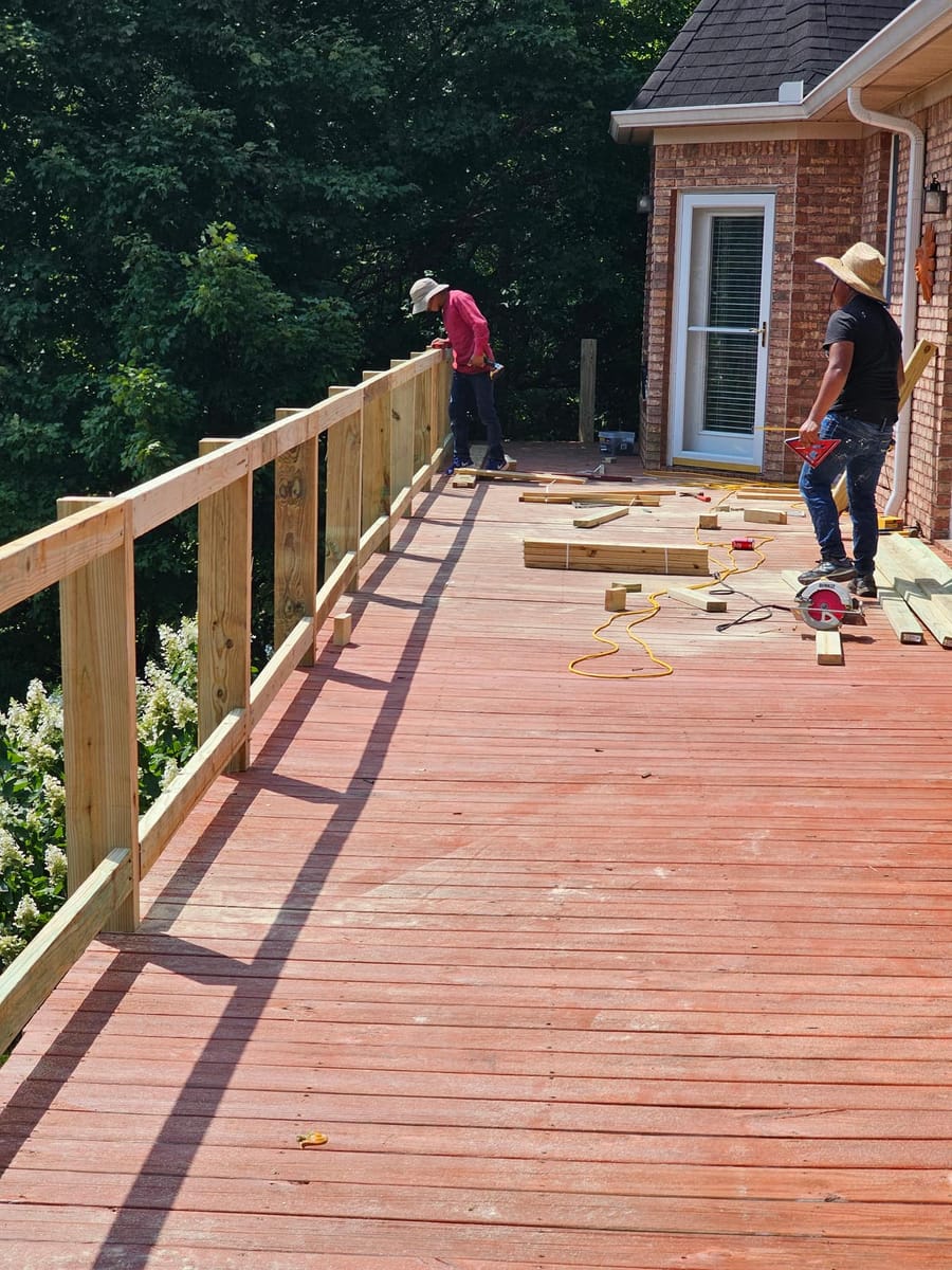 New timber railing installed along a long stained deck overlooking open water, Cartersville, Georgia