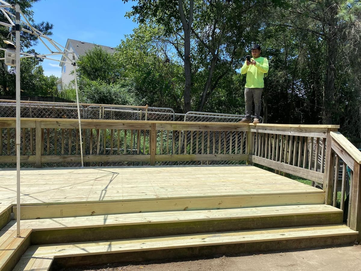 Ground-level deck stripped to the joists and re-decked, existing railings retained, Cumming, Georgia