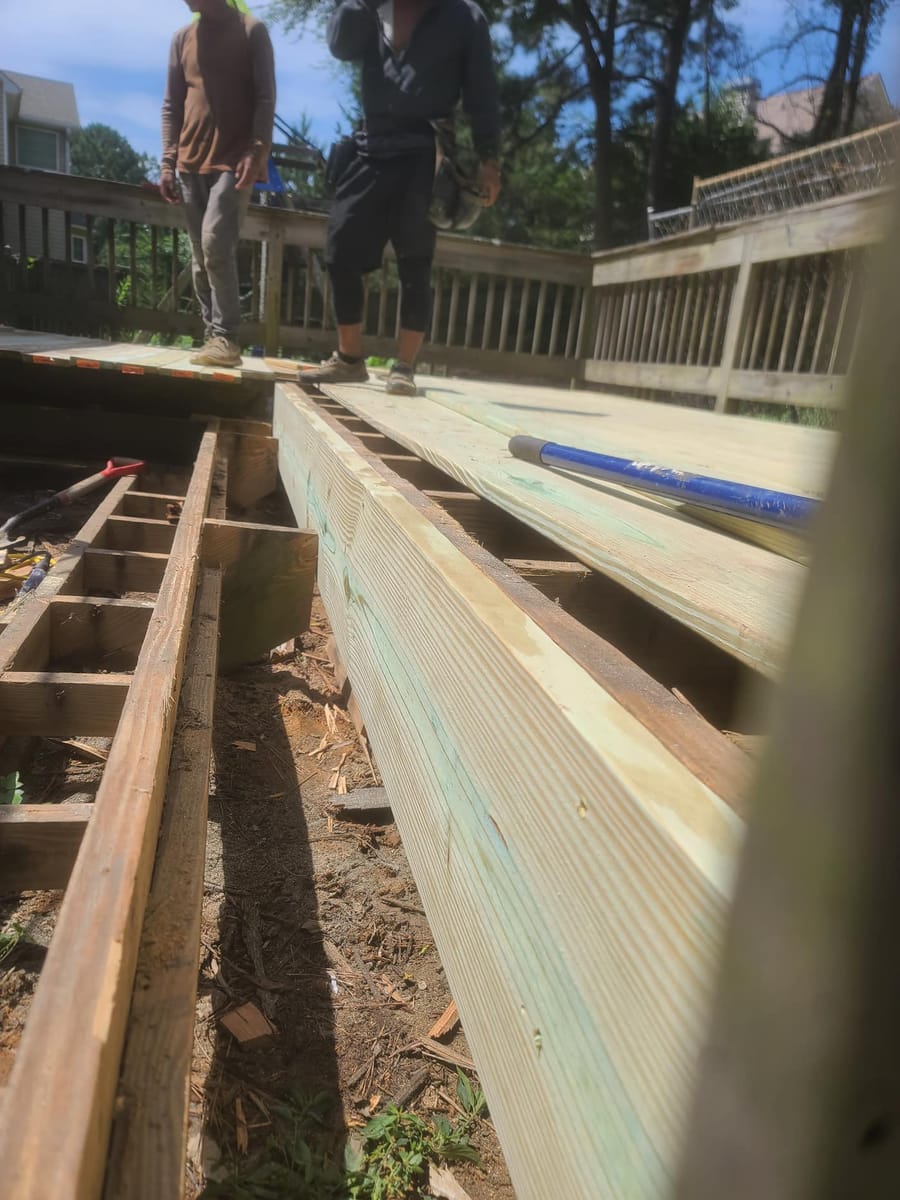Old boards lifted, exposing the joist frame, Cumming, Georgia