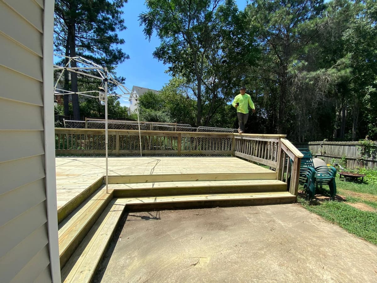 Ground-level deck stripped to the joists and re-decked, existing railings retained, Cumming, Georgia