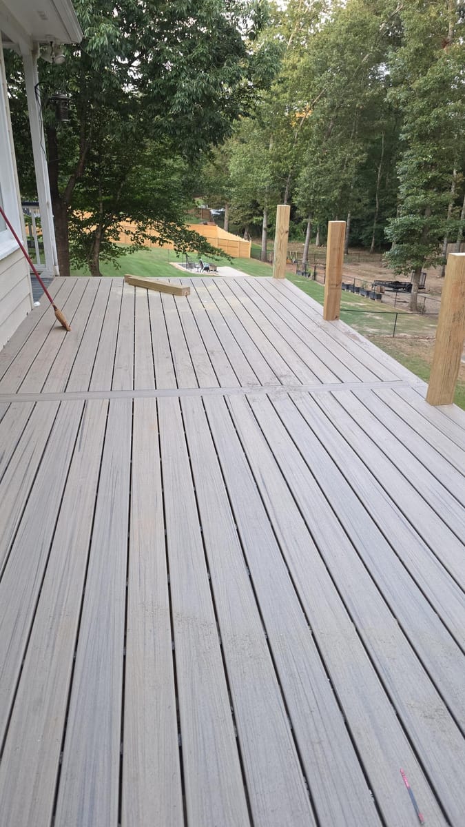 Weathered boards replaced with gray Trex composite decking on the existing frame beneath a covered deck, Kingston, Georgia
