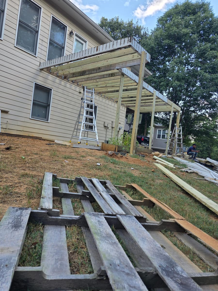 Weathered boards replaced with gray Trex composite decking on the existing frame beneath a covered deck, Kingston, Georgia