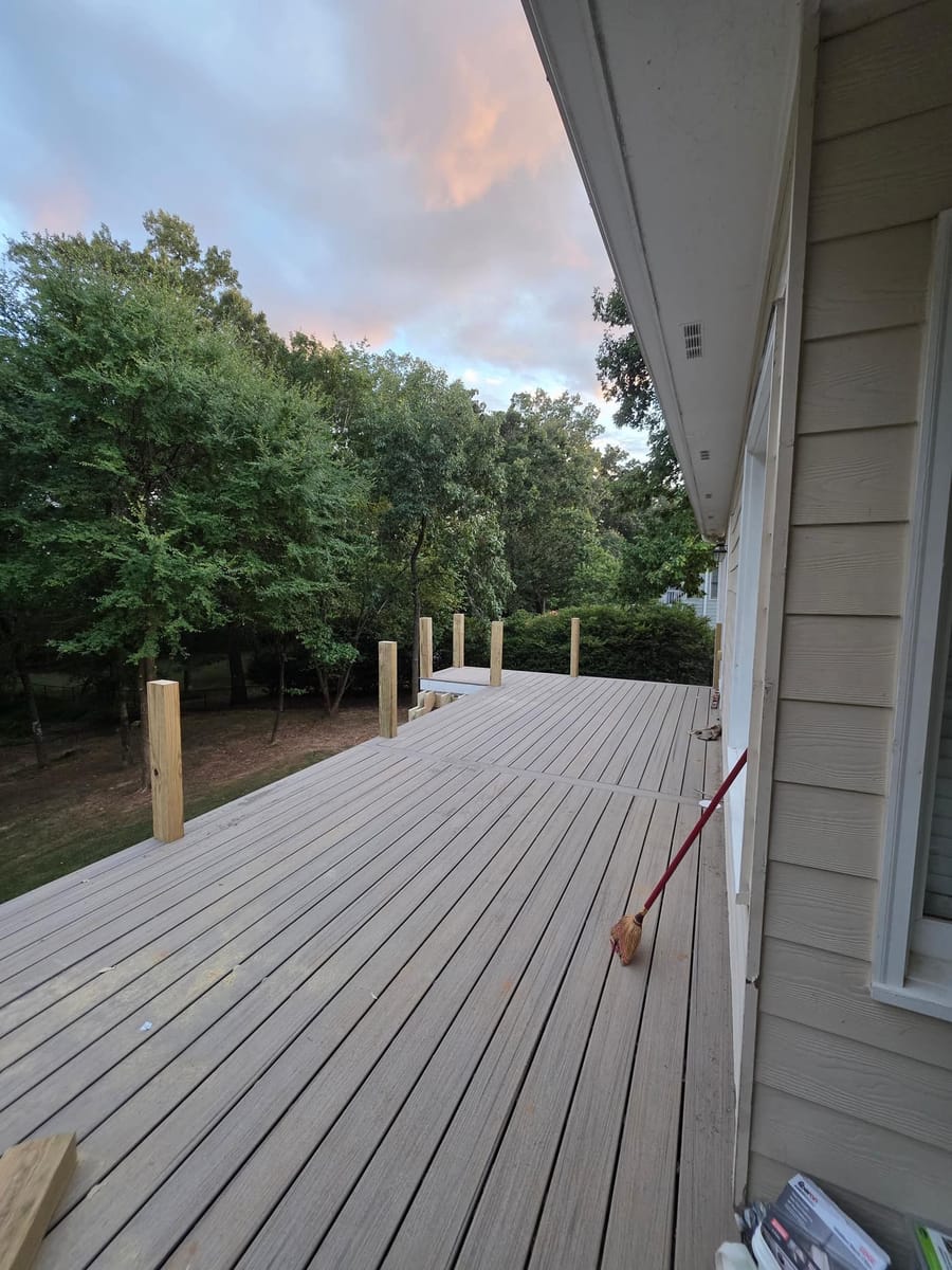 Weathered boards replaced with gray Trex composite decking on the existing frame beneath a covered deck, Kingston, Georgia