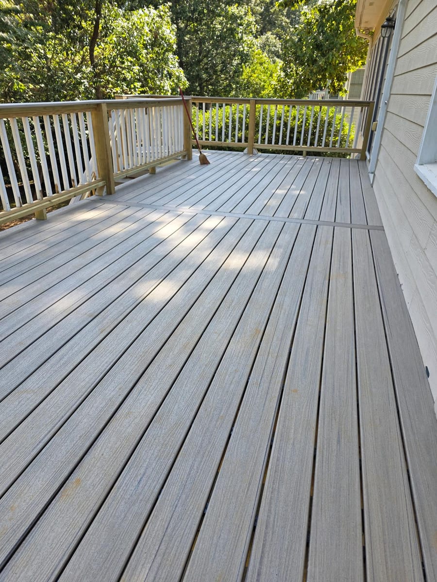Weathered boards replaced with gray Trex composite decking on the existing frame beneath a covered deck, Kingston, Georgia