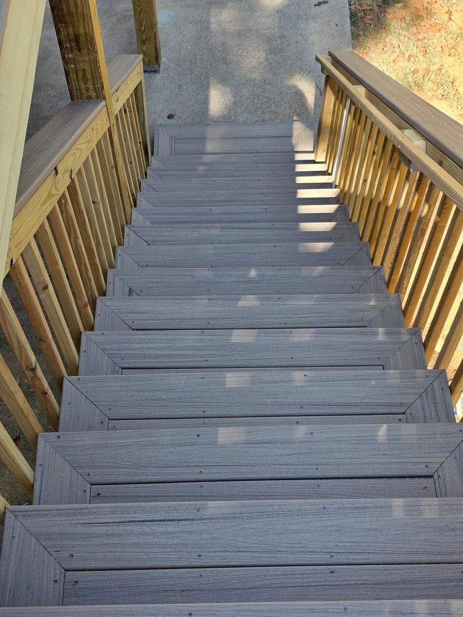 Weathered boards replaced with gray Trex composite decking on the existing frame beneath a covered deck, Kingston, Georgia
