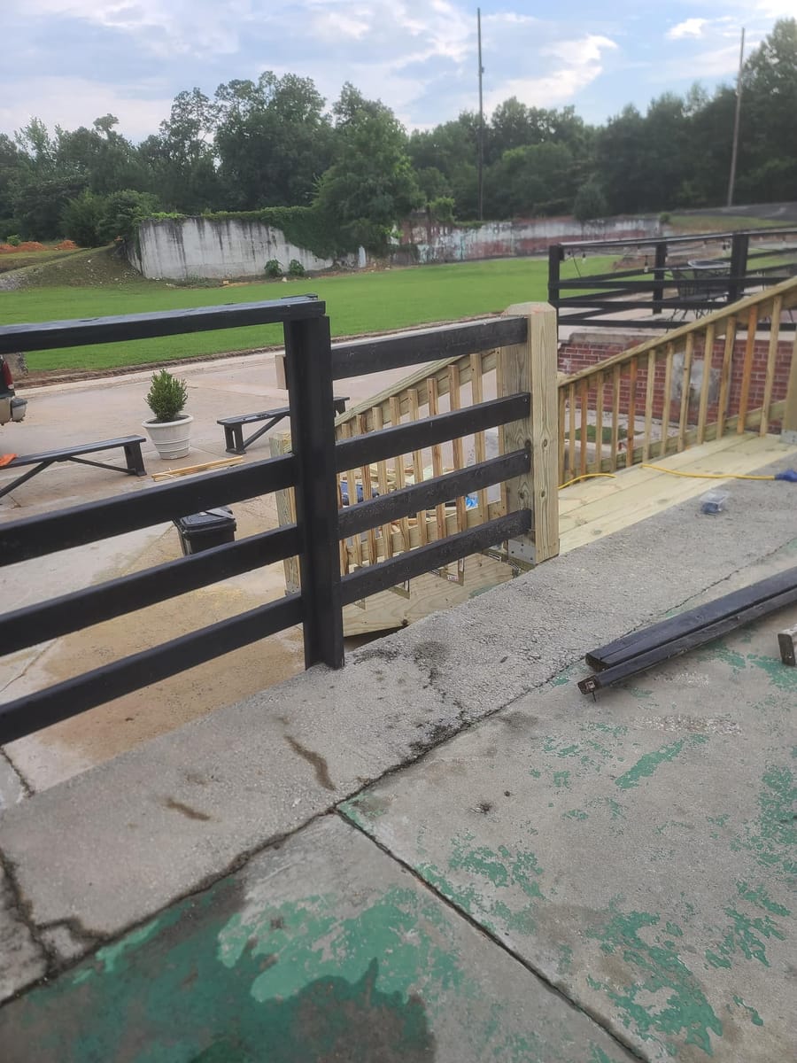 New timber stair and handrail run built against a historic brick mill building, Rome, Georgia