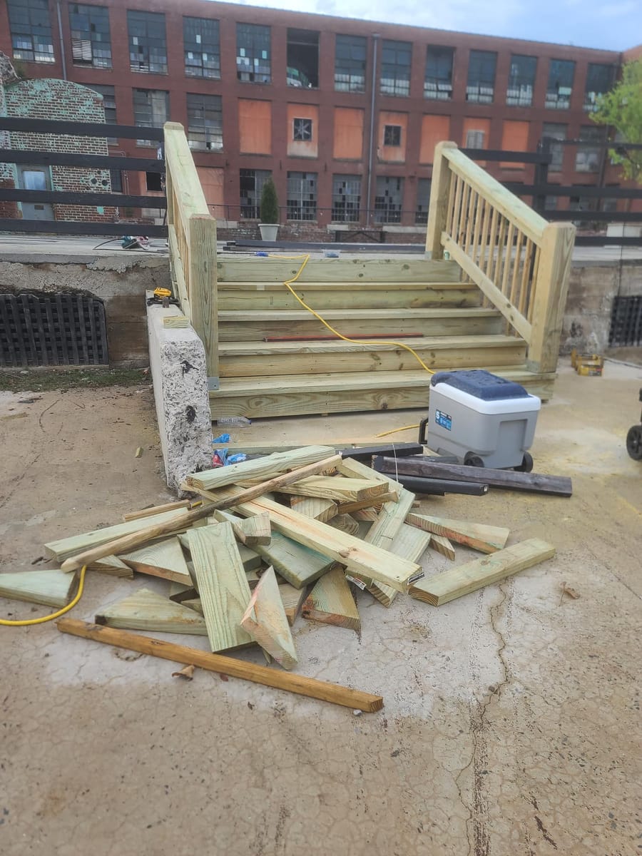 New timber stair and handrail run built against a historic brick mill building, Rome, Georgia