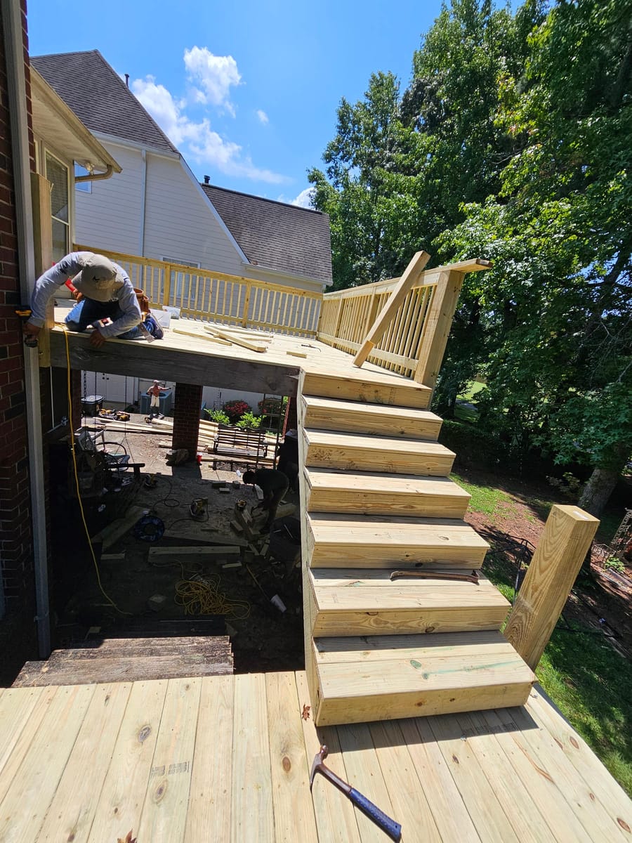 Deck re-boarded and stairs rebuilt on a brick home, existing lattice skirting retained, South Fulton, Georgia