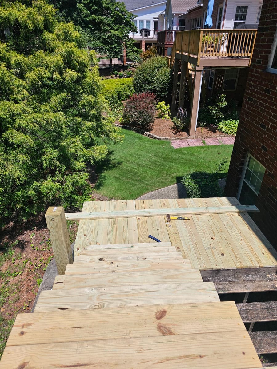 Deck re-boarded and stairs rebuilt on a brick home, existing lattice skirting retained, South Fulton, Georgia
