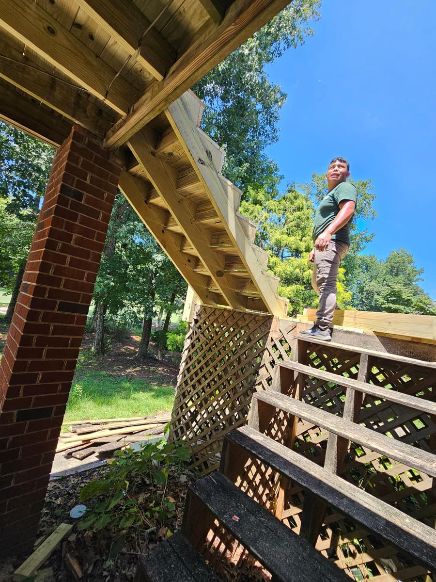 Deck re-boarded and stairs rebuilt on a brick home, existing lattice skirting retained, South Fulton, Georgia